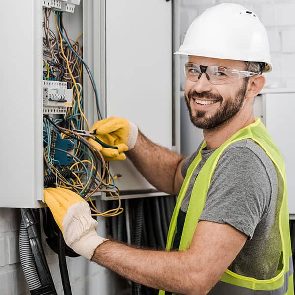 An electician working on an electrical panel