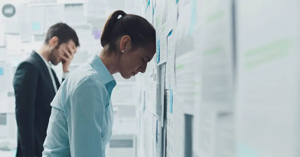 Stressed and exhausted marketing team reviewing project deadlines