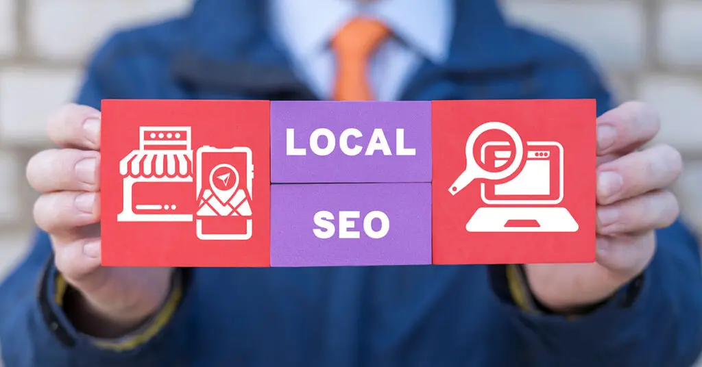 person holding a sign labeled local seo