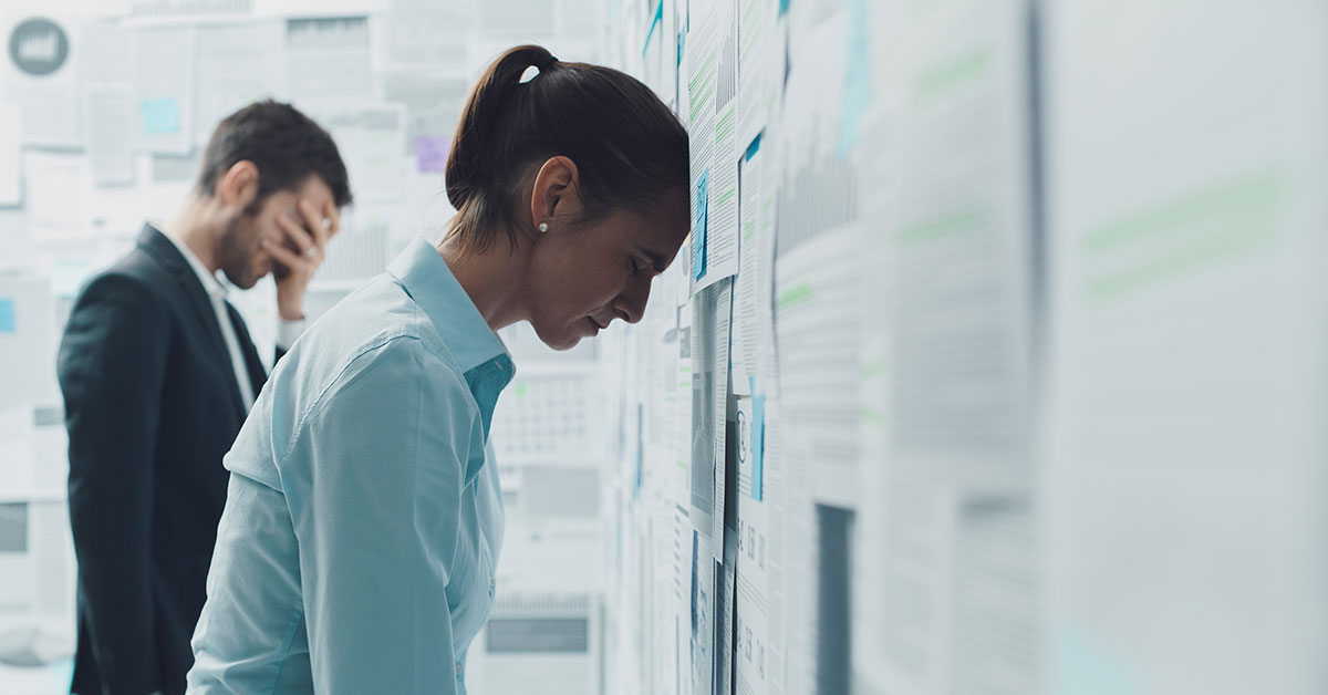 Stressed and exhausted marketing team reviewing project deadlines