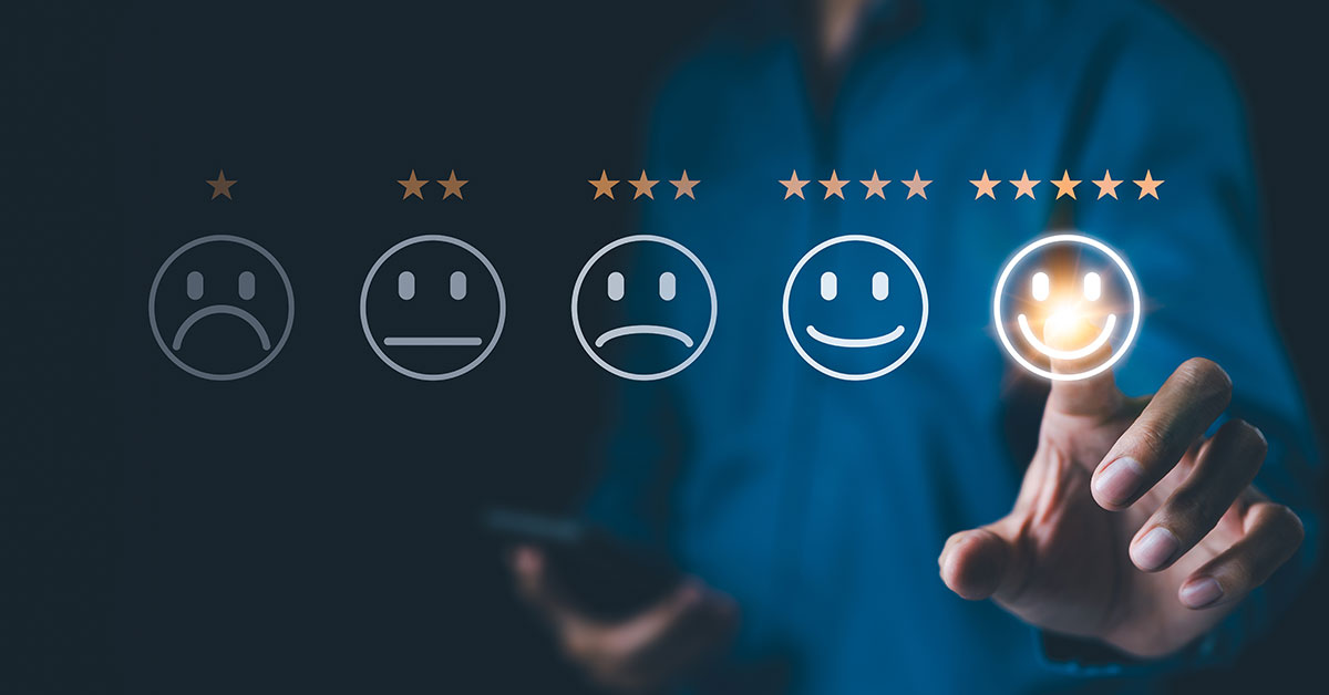 A happy customer smiling while leaving a 5-star review on their smartphone after a local service visit